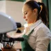 A female barista making coffee